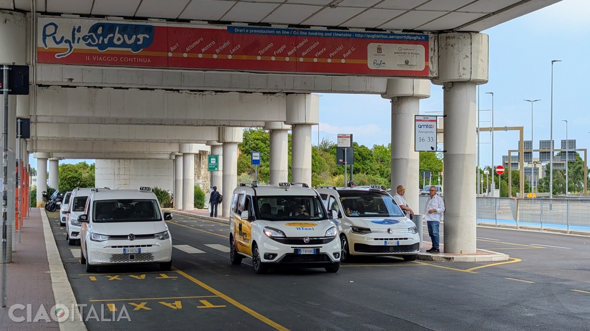 Mașinile de taxi așteaptă &icirc;n fața aeroportului.
