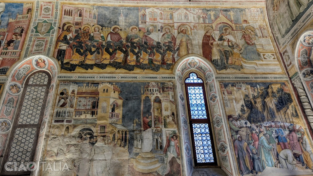 În partea de sus a frescei sunt reprezentați membrii familiei Lupi, îmbrăcați în armură și însoțiți de sfinții patroni, îngenunchind în fața Fecioarei Maria.